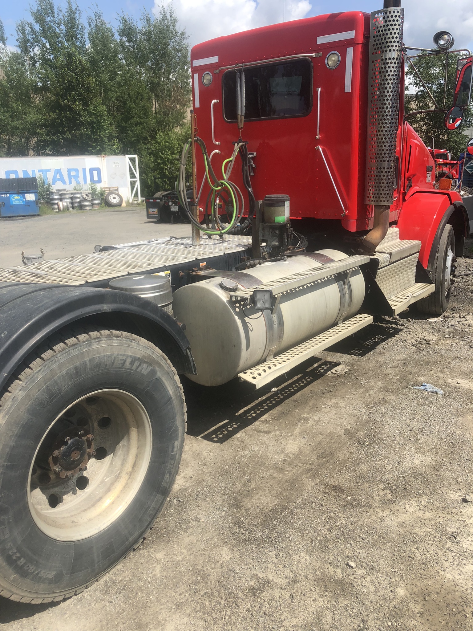 Dirty side of red transport truck before wash